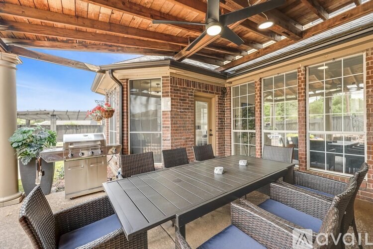 A patio with a table and chairs is shown.