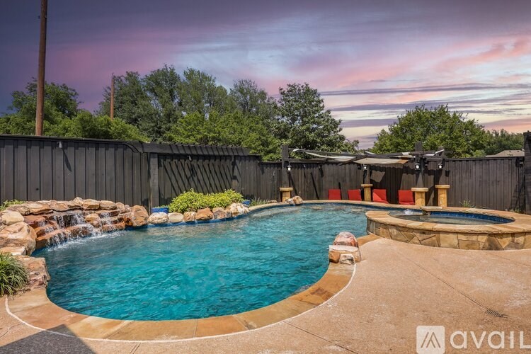 A backyard with a pool and a hot tub.