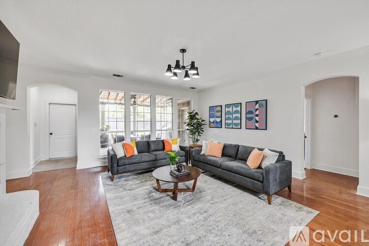 A living room with a grey couch and a coffee table.