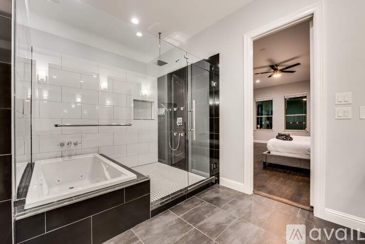 A modern bathroom with a glass shower and a walk-in shower.