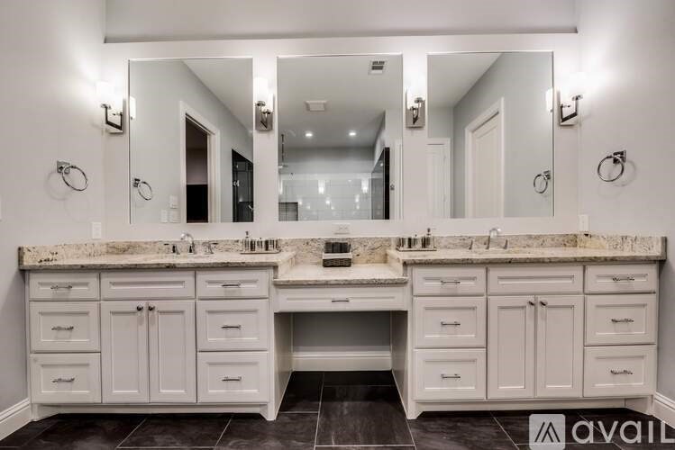 A bathroom with two sinks and a large mirror.