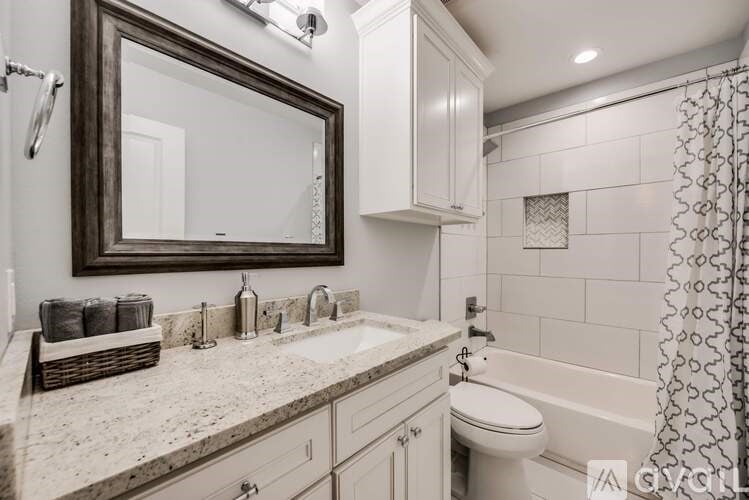 A bathroom with a white toilet, sink, and a mirror.