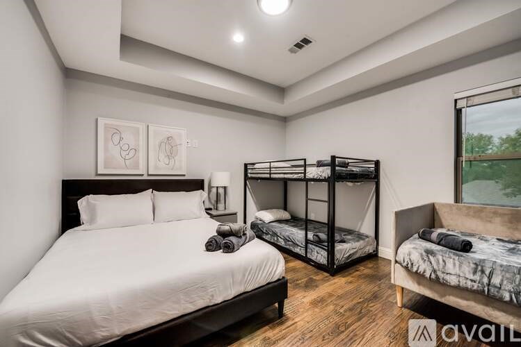 A bedroom with a large bed and a bunk bed.