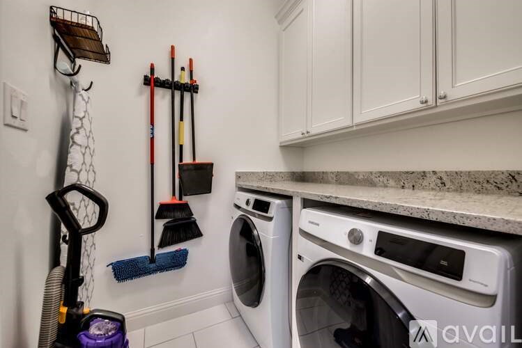 A white washing machine and dryer in a laundry room.