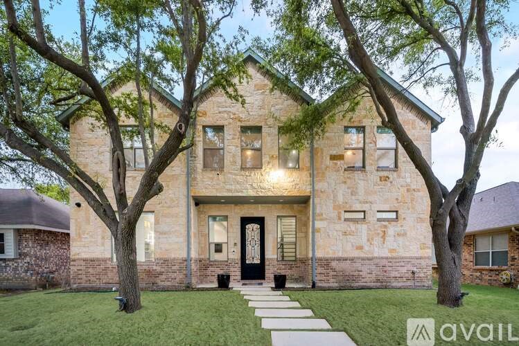 A house with a front yard and trees.