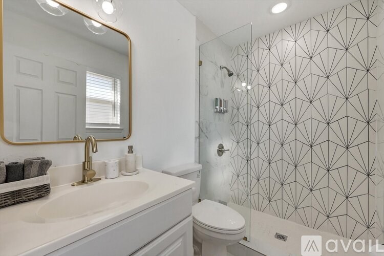 A bathroom with a white sink and a mirror.