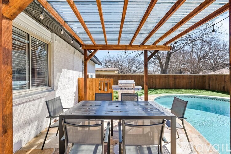 A patio with a table and chairs is shown.