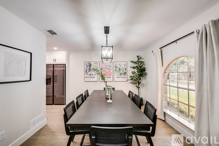 A dining room with a long table and chairs.