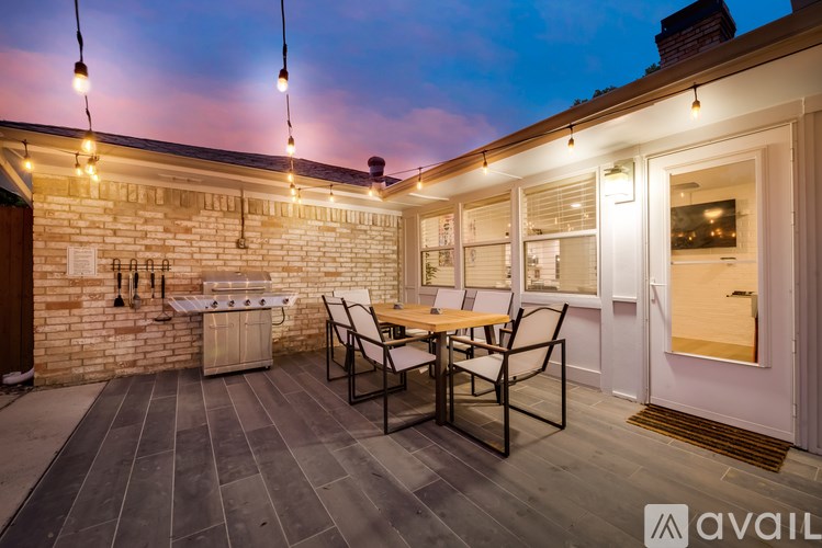 A patio with a table and chairs is set up outside a house.