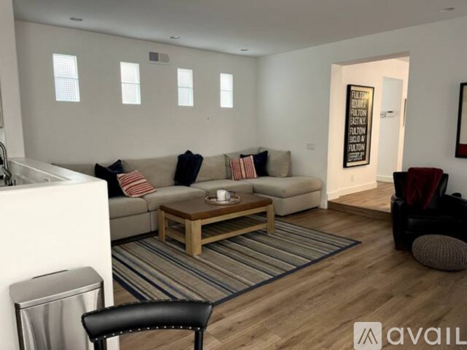 A living room with a sofa, a coffee table, and a chair.