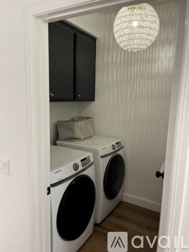 A small laundry room with a washer and dryer.