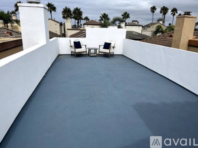 A patio with two chairs and a table is available for rent.