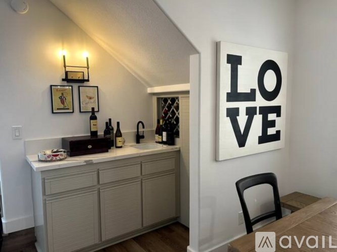 A kitchen with a large LOVE sign on the wall.