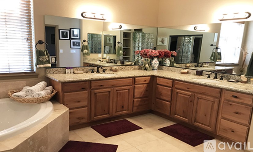 A bathroom with a large vanity and a bathtub.