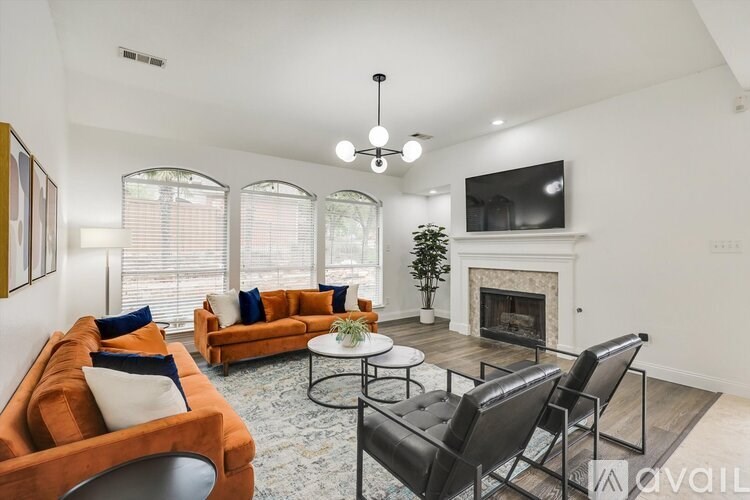 A living room with a fireplace and a television.