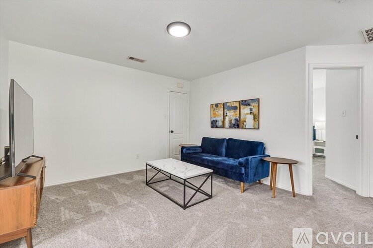 A living room with a blue couch and a television.