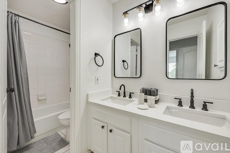 A bathroom with a white sink and a white toilet.