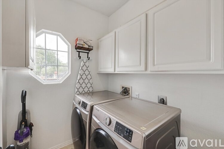A small laundry room with a washer and dryer.
