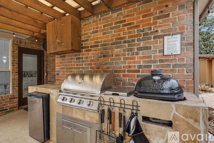 A brick wall with a grill and a sign on it.