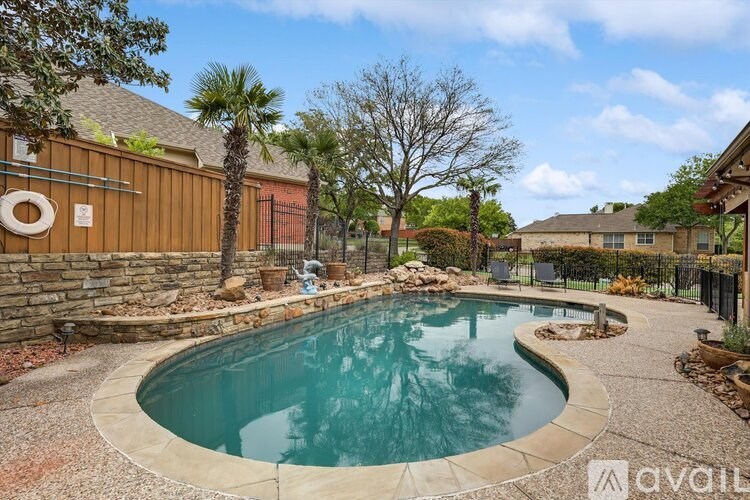 A small kidney-shaped pool with a stone border.