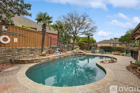 A small kidney-shaped pool with a stone border.
