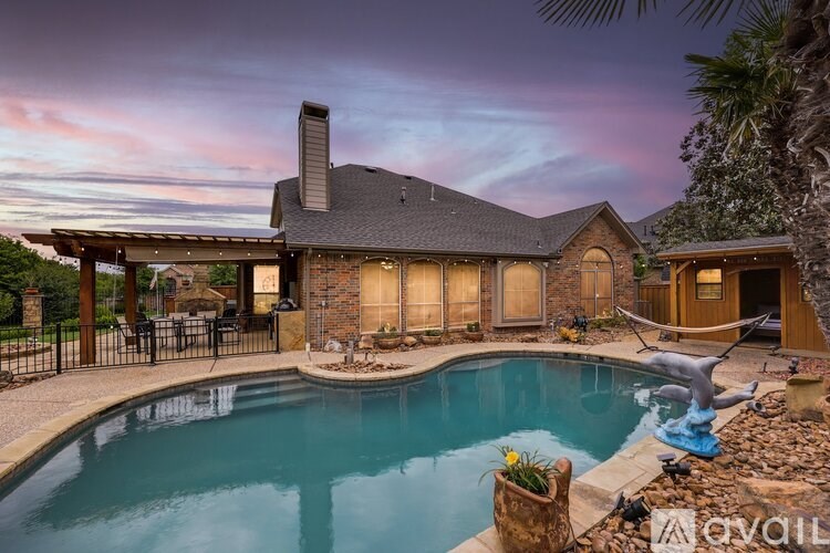 A house with a pool in front of it.