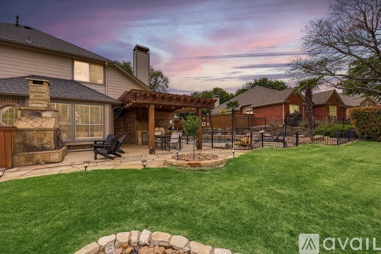 A house with a patio and a stone wall.