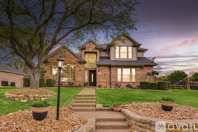 A house with a front yard and a tree.