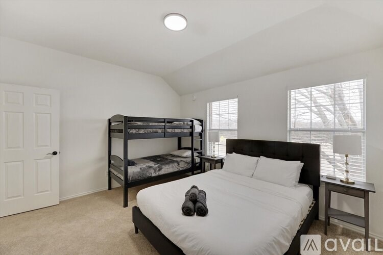 A bedroom with a bunk bed and a single bed.