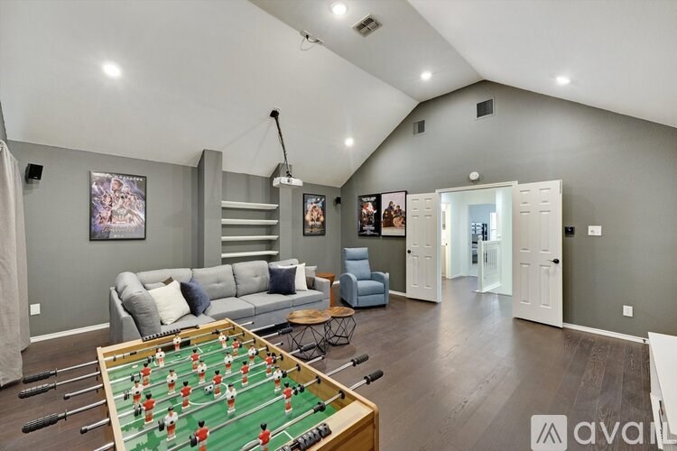A foosball table sits in the middle of a living room.