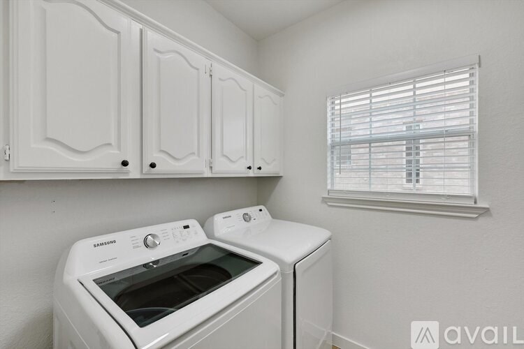 A white Samsung dishwasher and oven in a kitchen.