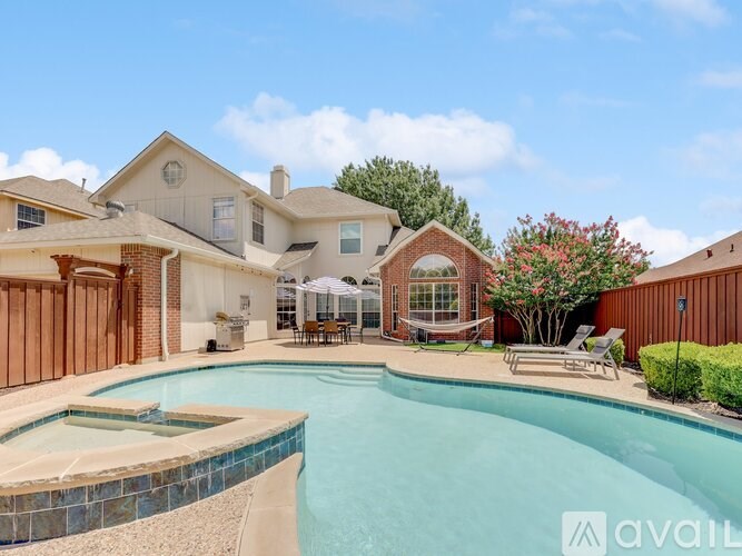 A large house with a pool in the backyard.