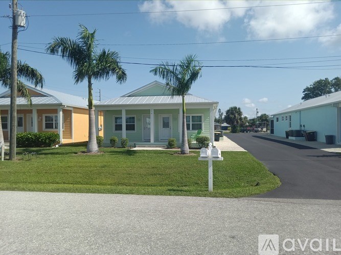 A row of houses with a sign in front of them.