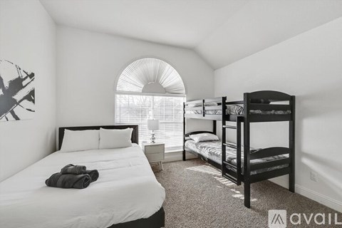 A bedroom with a large bed and a bunk bed.