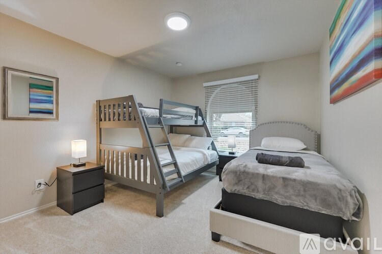 A bedroom with a bunk bed and a single bed.