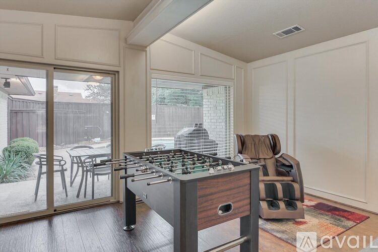 A kitchen with a stove top oven and a dining table outside.