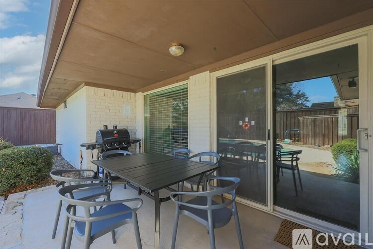 A patio with a table and chairs is shown.