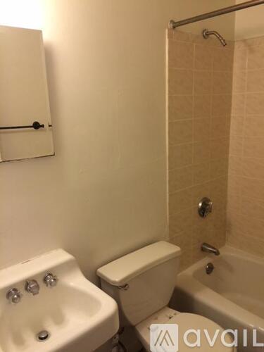 A white sink and toilet in a small bathroom.
