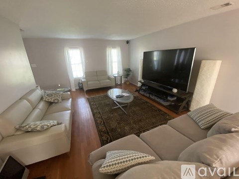A living room with a large couch and a television.