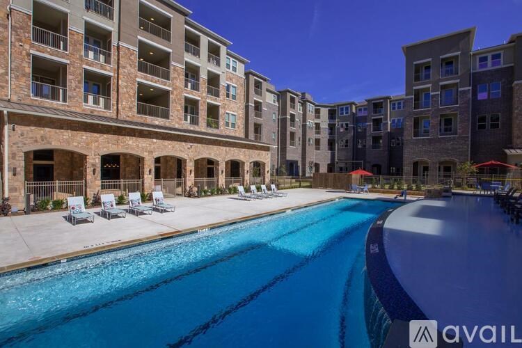 A large swimming pool in front of apartment buildings.