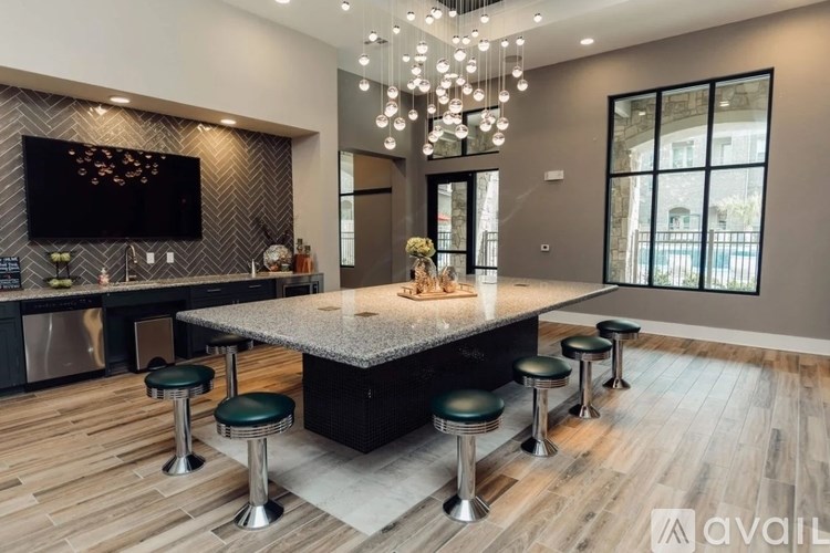 A modern kitchen with a central island and a bar area.