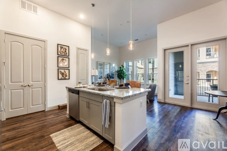 A kitchen with a white countertop and wooden floors.