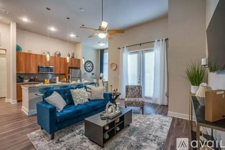 A living room with a blue couch and a coffee table.