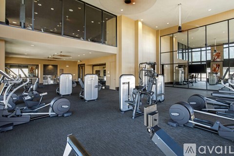 A gym with a variety of equipment including treadmills, weights, and exercise machines.