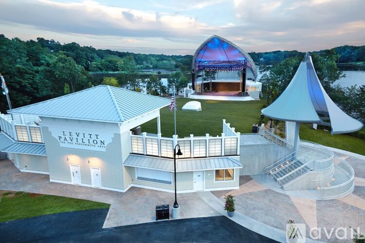 Levitt Pavilion is a white building with a stage and a large tent.