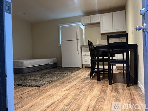 A kitchen area with a table and chairs.