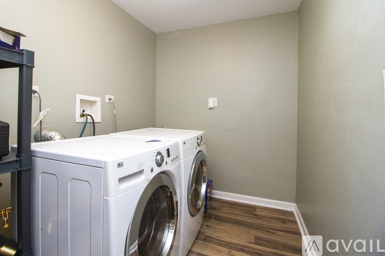 A white front load washing machine in a laundry room.