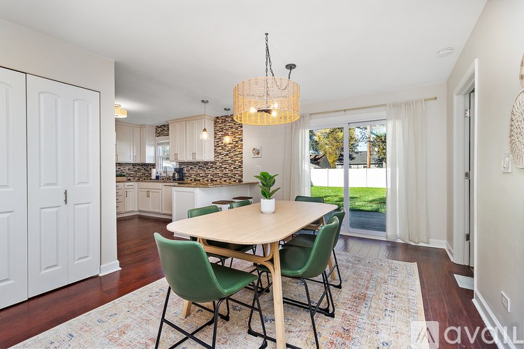 A dining room with a wooden table and chairs.