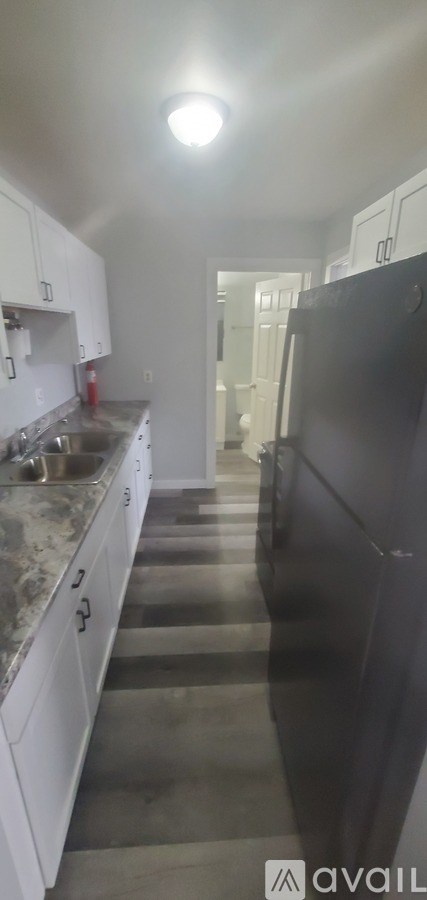 A kitchen with white appliances and brown cabinets.