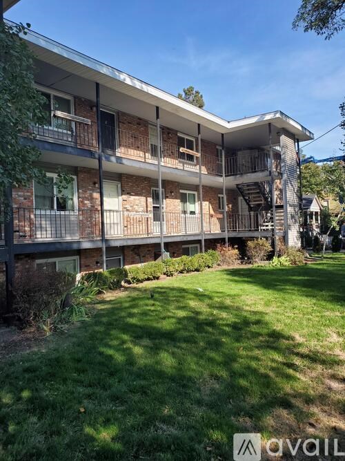 A sunny day at the apartment complex with green grass and a clear blue sky.